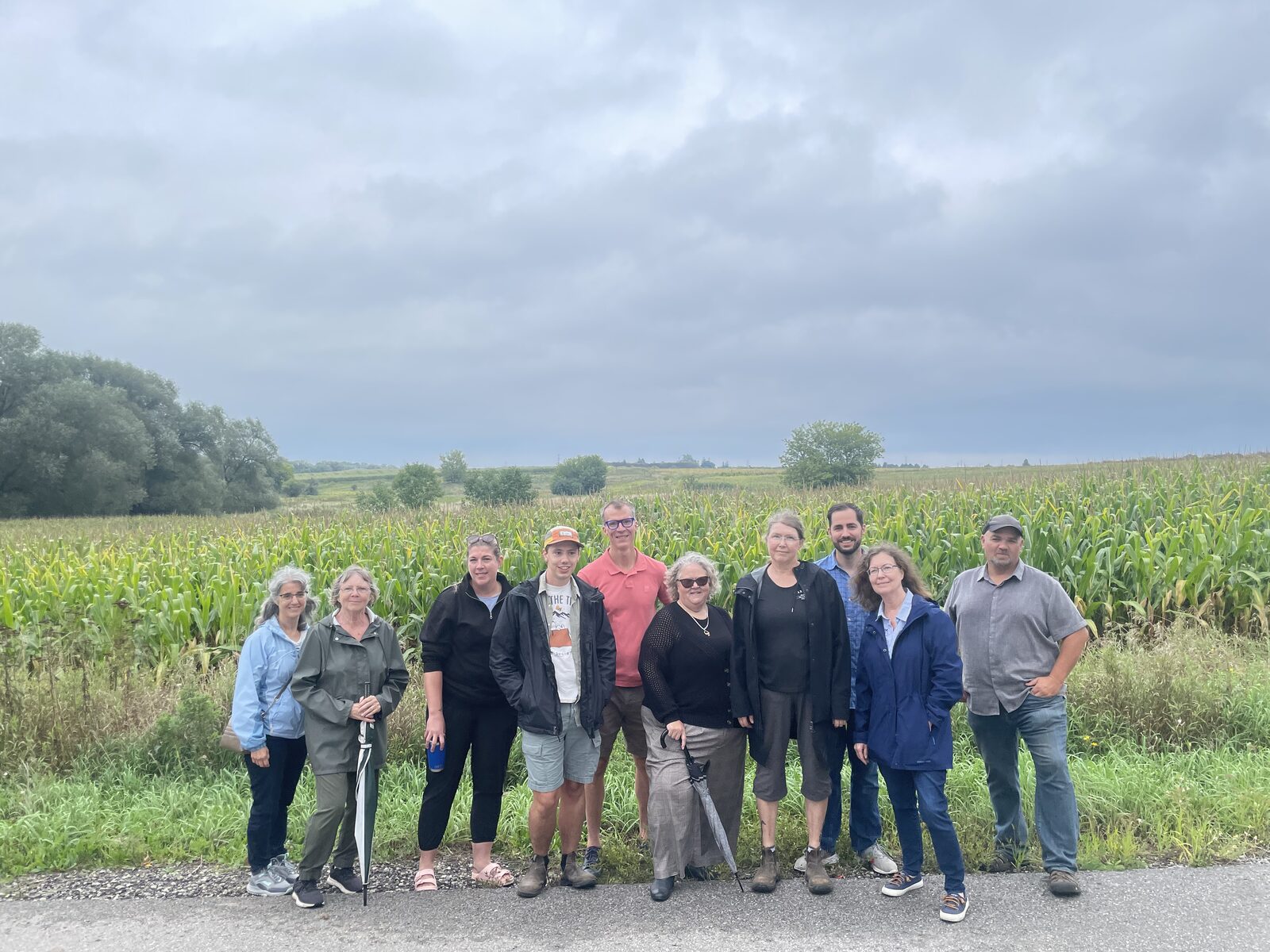 Neighbours standing beside active farmland near the proposed Gateway Employment Lands