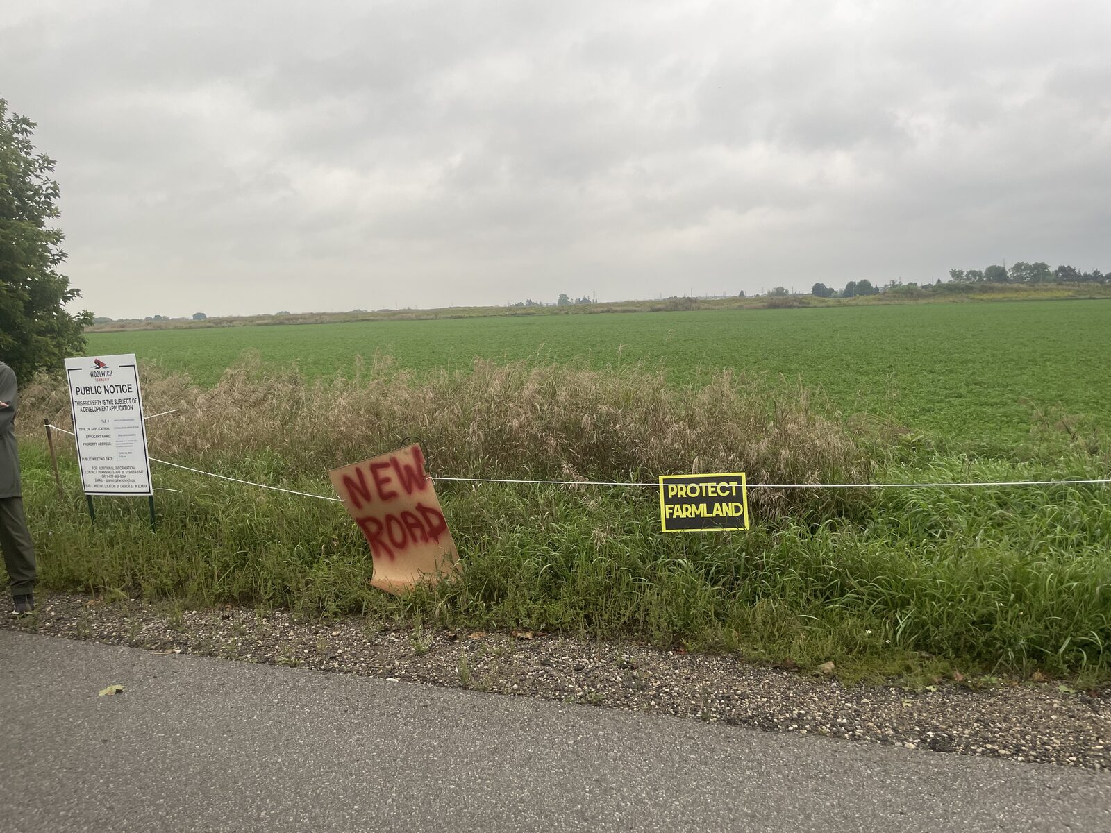 Township public notice and Protect Farmland signs along farmland