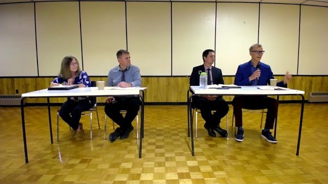 The four candidates at the front of the St. Jacobs Lions Hall during the September 28 town hall
